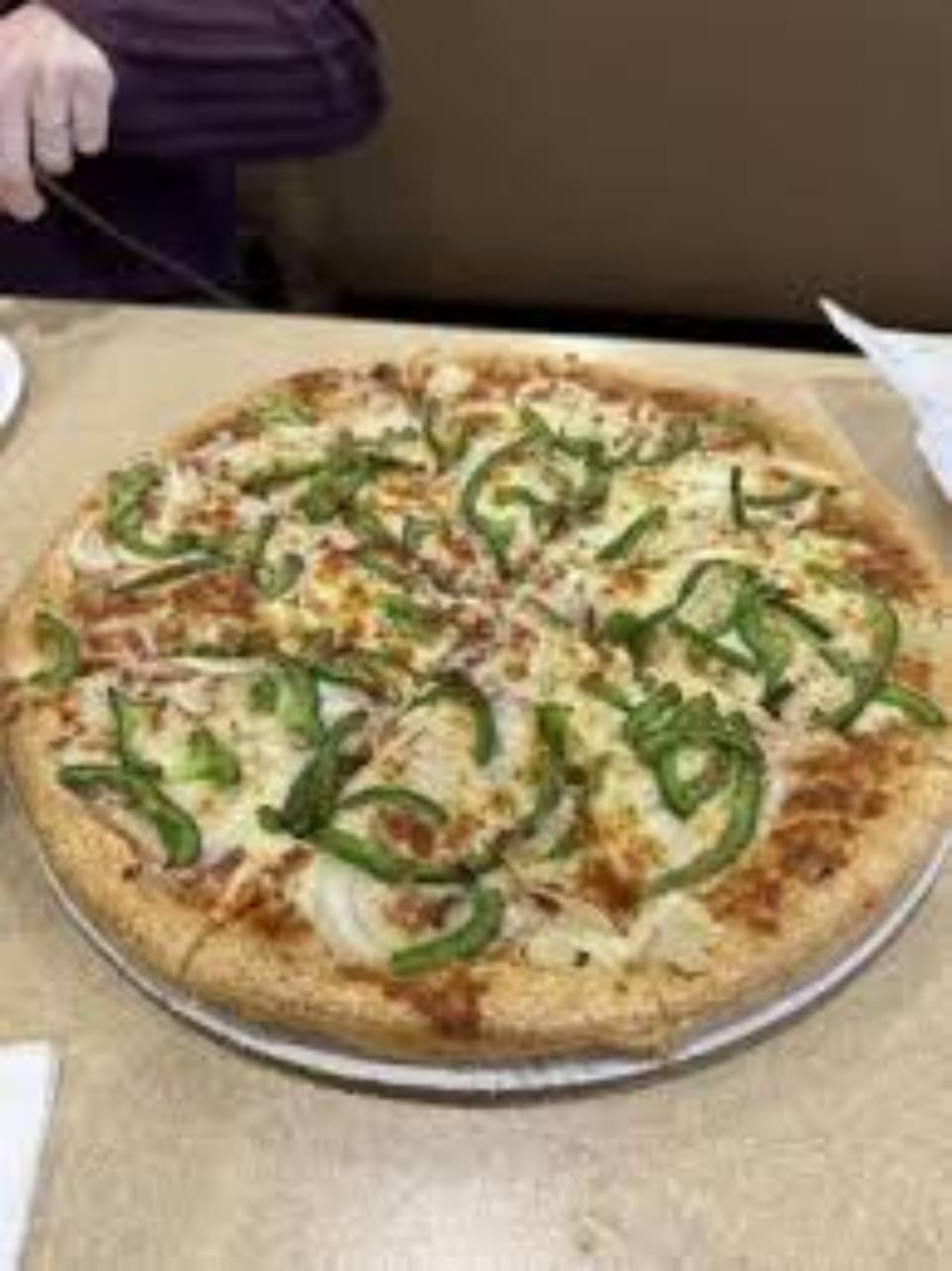 Pizza topped with green peppers and onions.